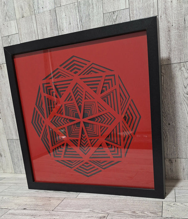 angled view of framed black and red paper