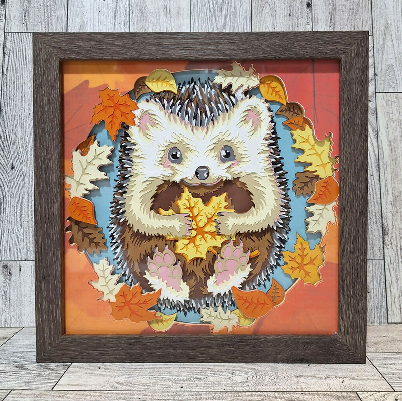 framed paper art hedgehog holding fall leaf